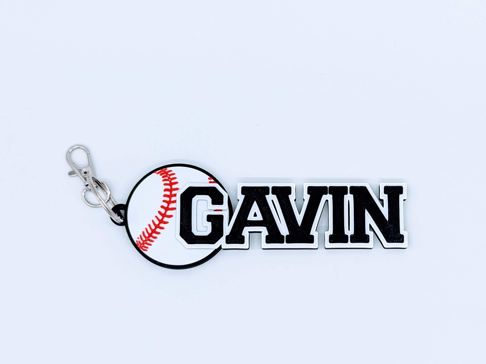 black baseball bag tag with custom engraved player number and name, ready to clip onto any sports bag.
