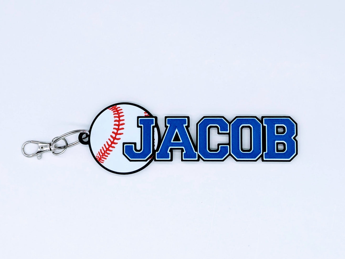 Bright blue baseball bag tag with custom engraved player number and name, ready to clip onto any sports bag.
